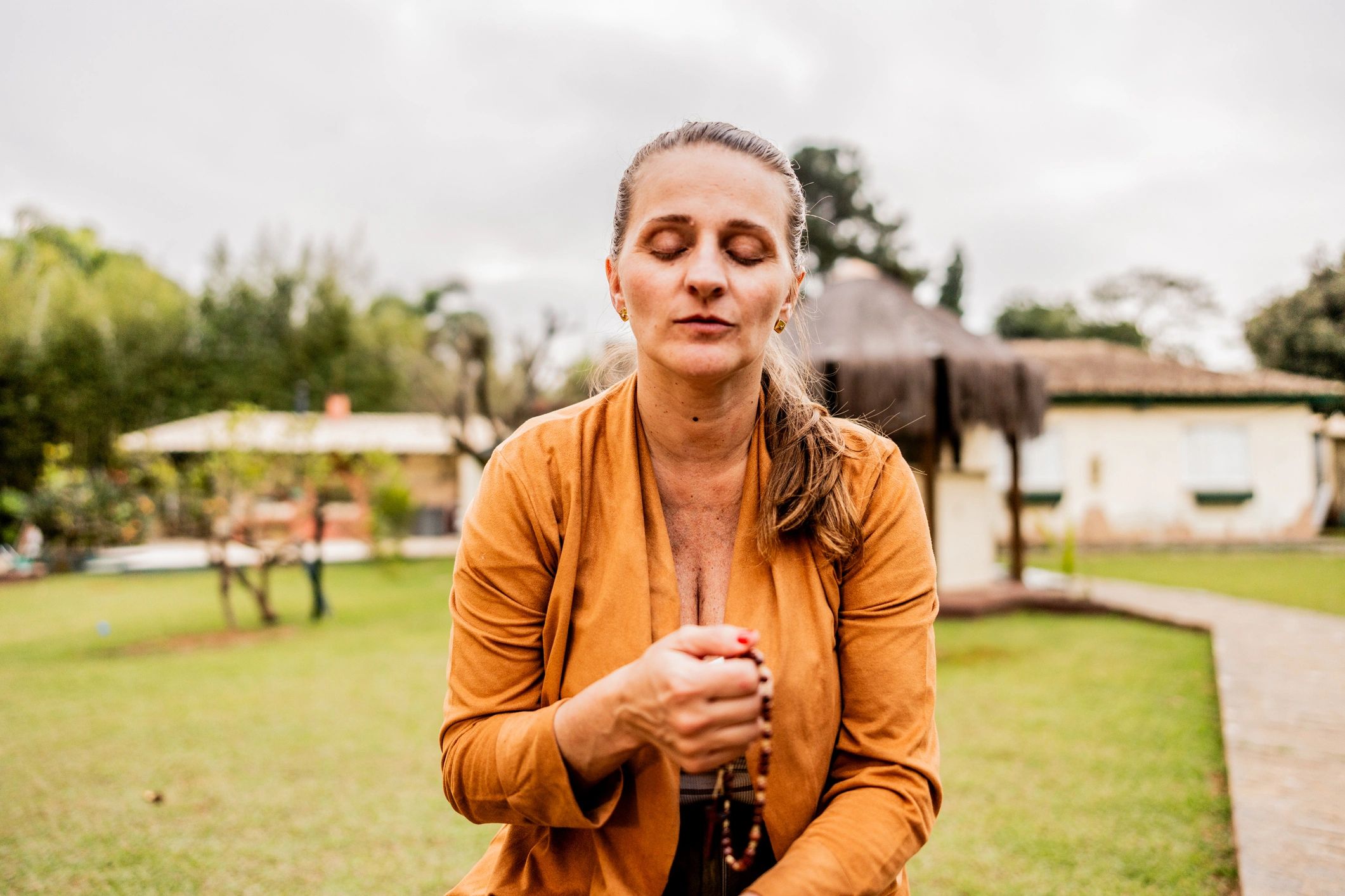 Woman in prayerful reflection representing mind-body healing