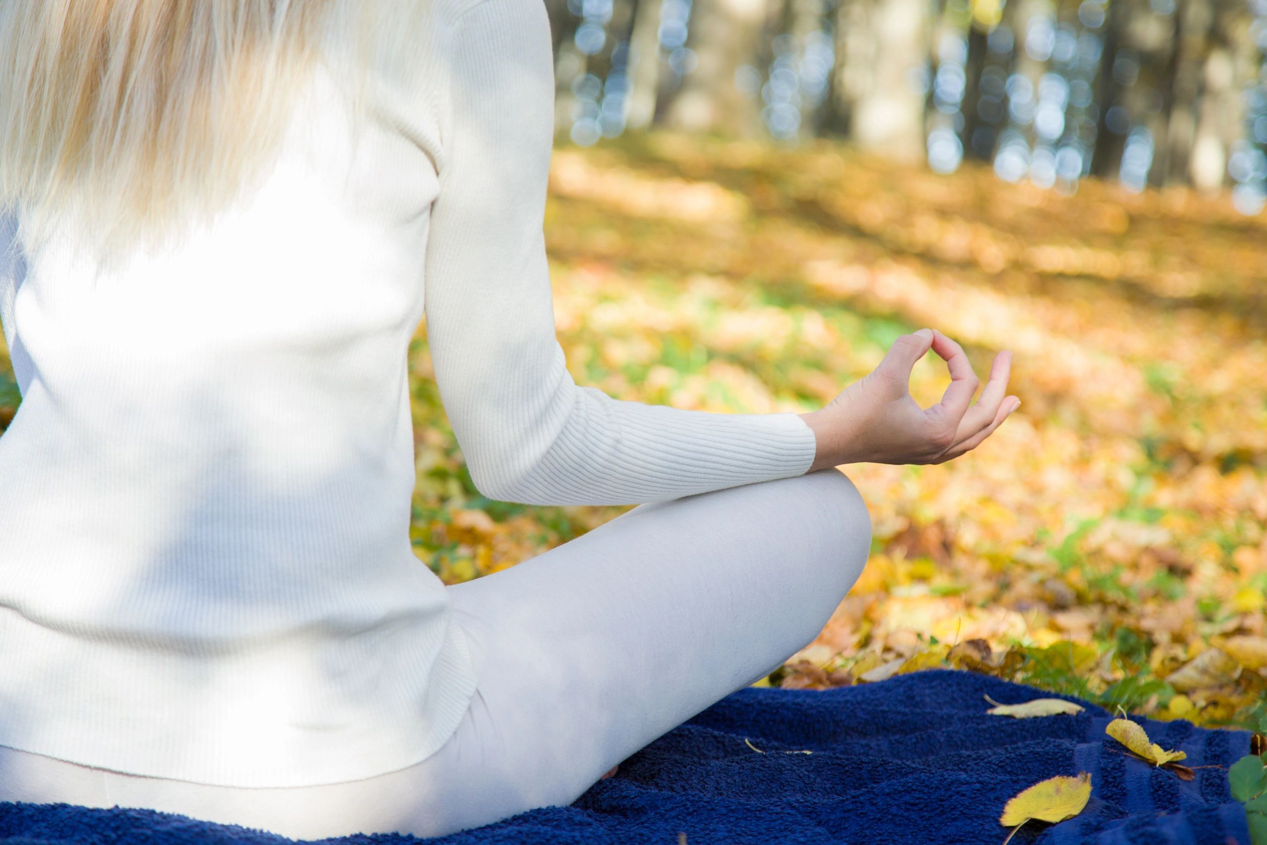 Woman practicing yoga outdoors in sunlight